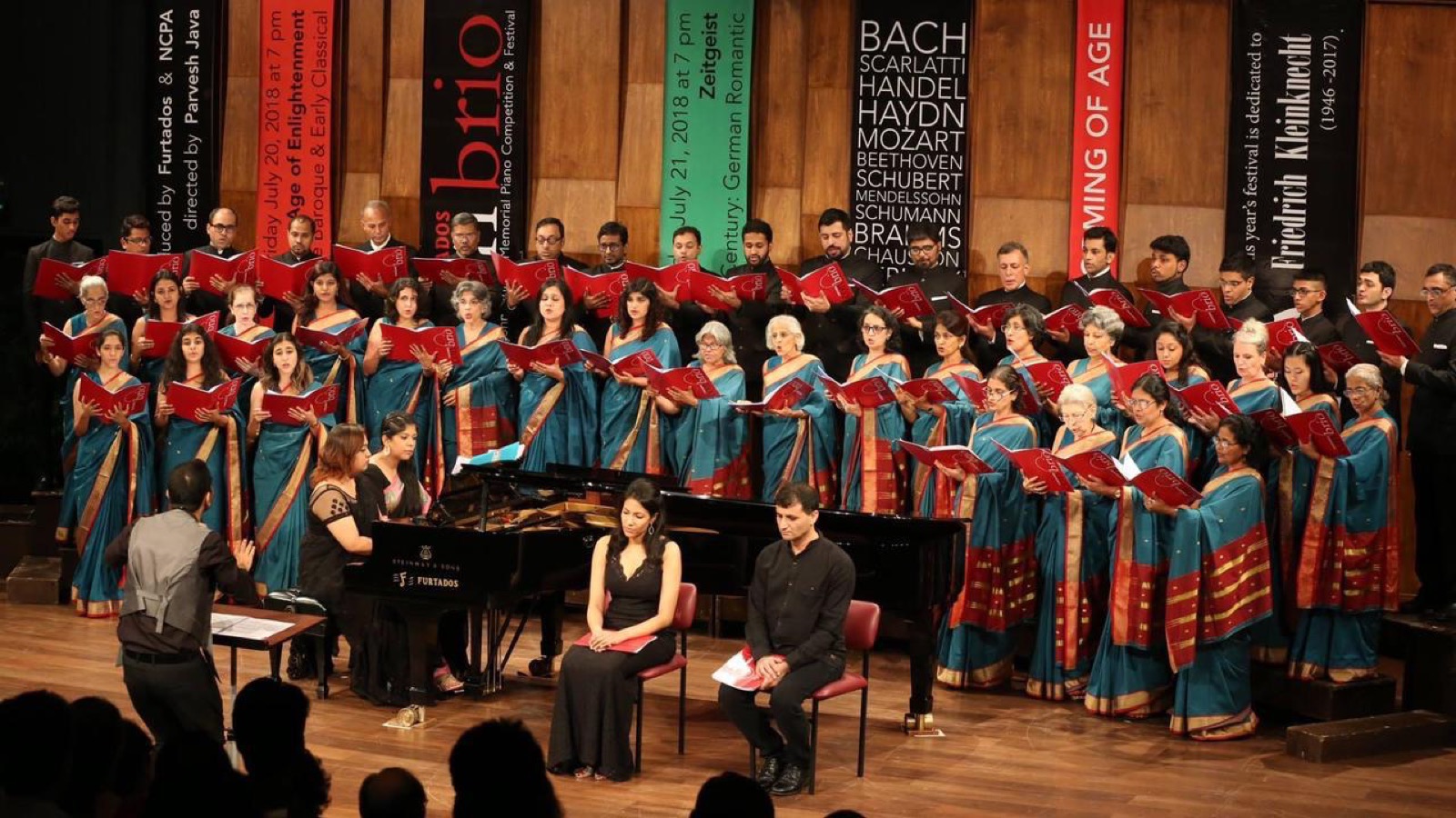 A large choir and piano performing at the Con Brio festival